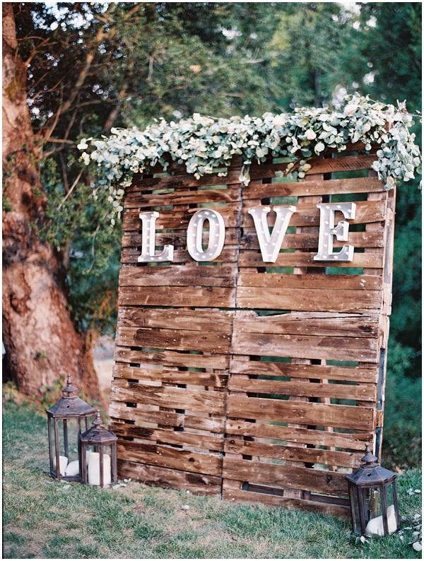 marquee love sign with greenery and florals 