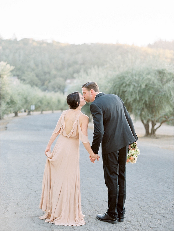 bride and groom walking in olive grove