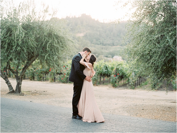 couple kissing in napa vineyards