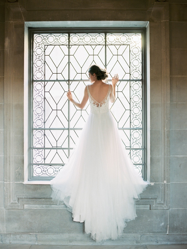bride standing in large San francisco city hall window
