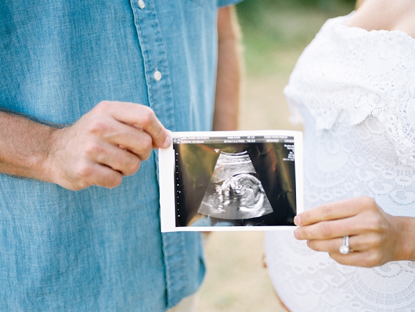 couple holding ultrasound for their maternity session