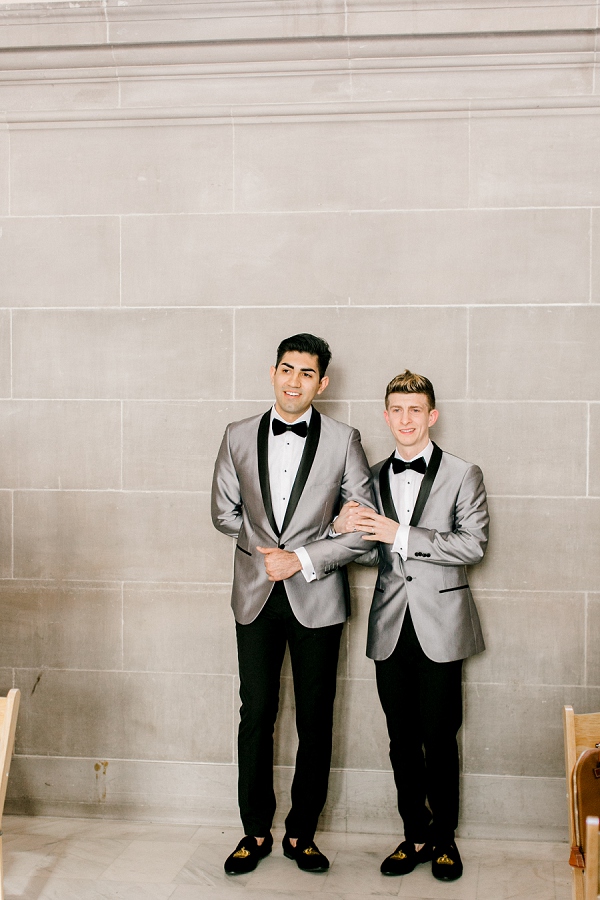 gay couple posing inside of san francisco city hall in their tuxedos for their wedding
