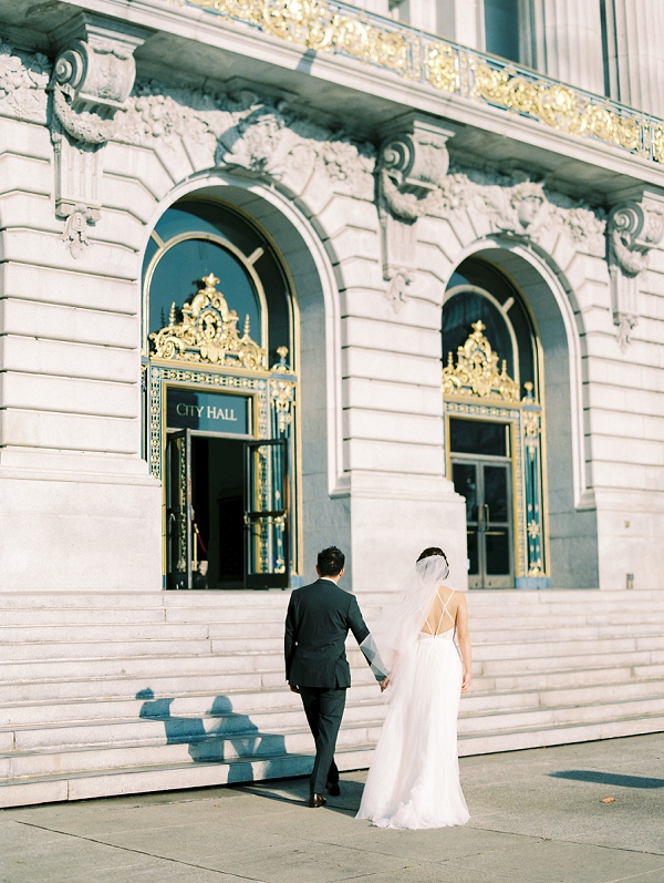 couple holding hands at San Francisco city hall for elopement