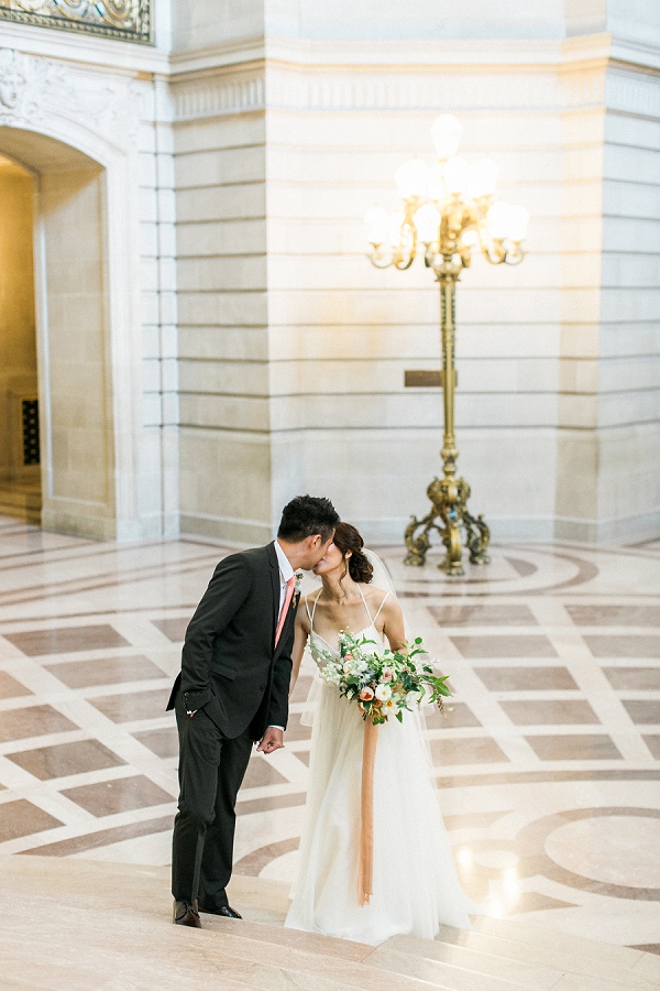 newlywed couple kissing in San Francisco city hall