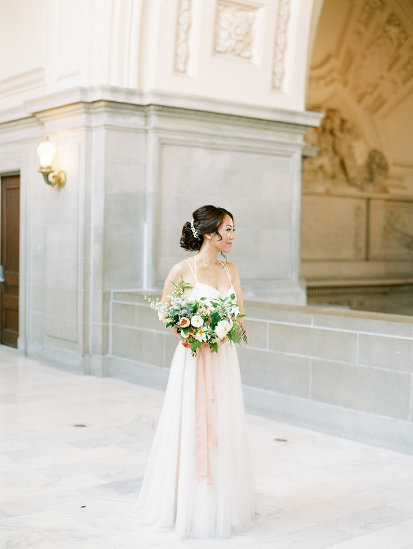 bridal pose on the fourth floor galleries inside of San Francisco city hall