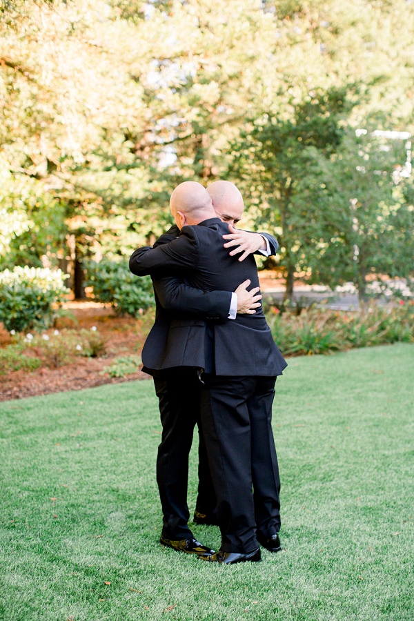 groom hugging officiant 