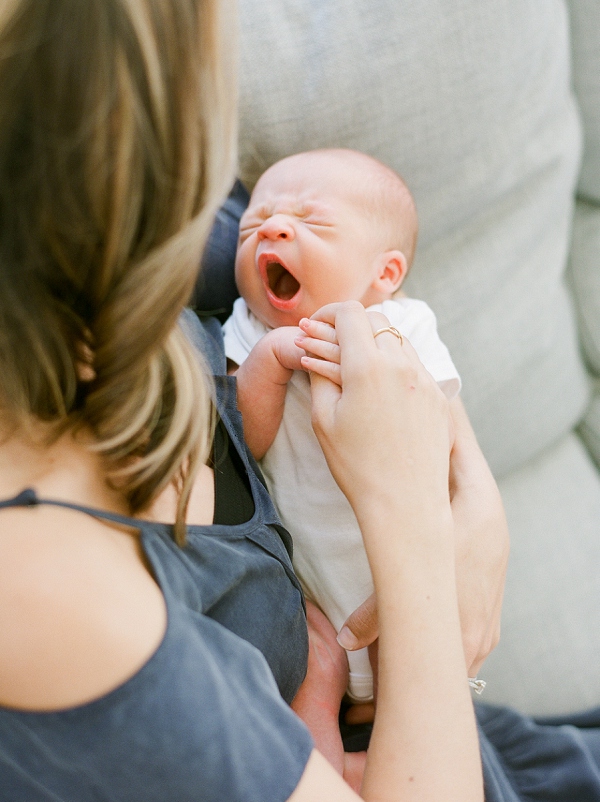 newborn photography San Francisco. Mom holding yawning baby