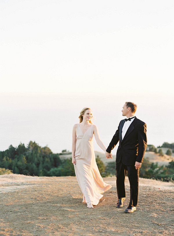 Mt Tam Engagement session. woman in flown pink dress holding man in tuxedo hand. near San Francisco in Marin County