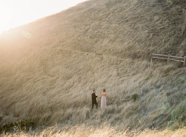 Mt Tamalpais Engagement session. woman is beautiful flowing pink dress holder her fiance's hand during Mt. Tamalpais California engagement session  by  Fine Art wedding photographer Jessica 