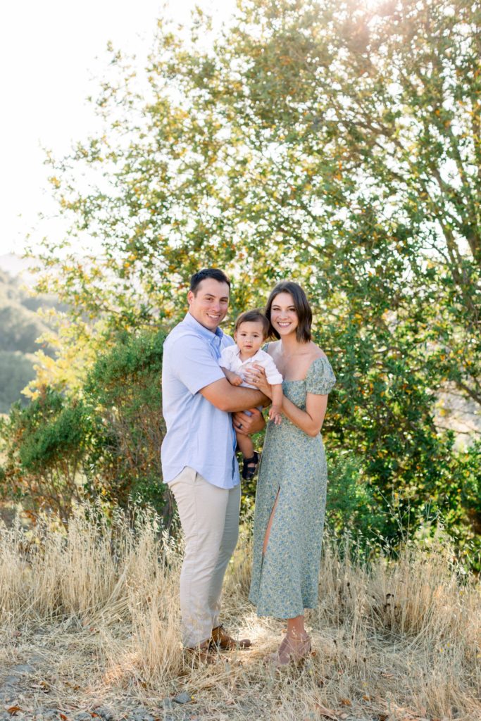 Orinda Family Photography Session with Jessica Kay Photography.  Father in blue shirt, song and mother in green dress with green foliage behind them