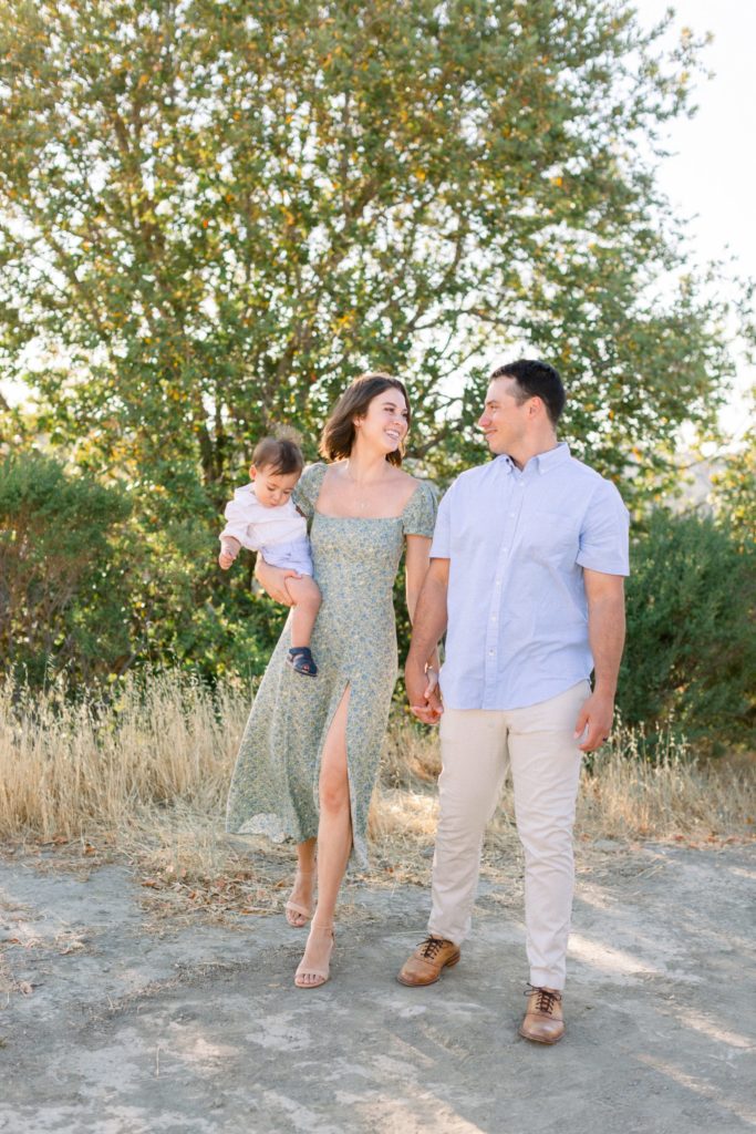 San Francisco Bay Area family photographer mother holding son with father next to her