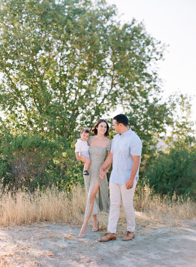 San Francisco Bay Area family photographer husband, wife, and toddler son being carried
