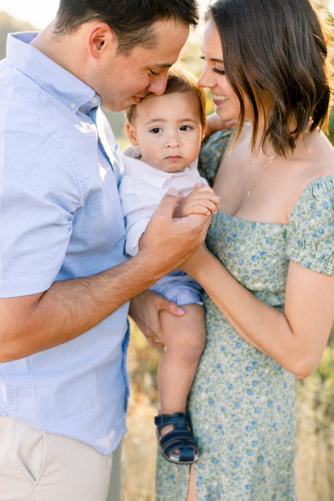 Childs being held by both parents in family photography session