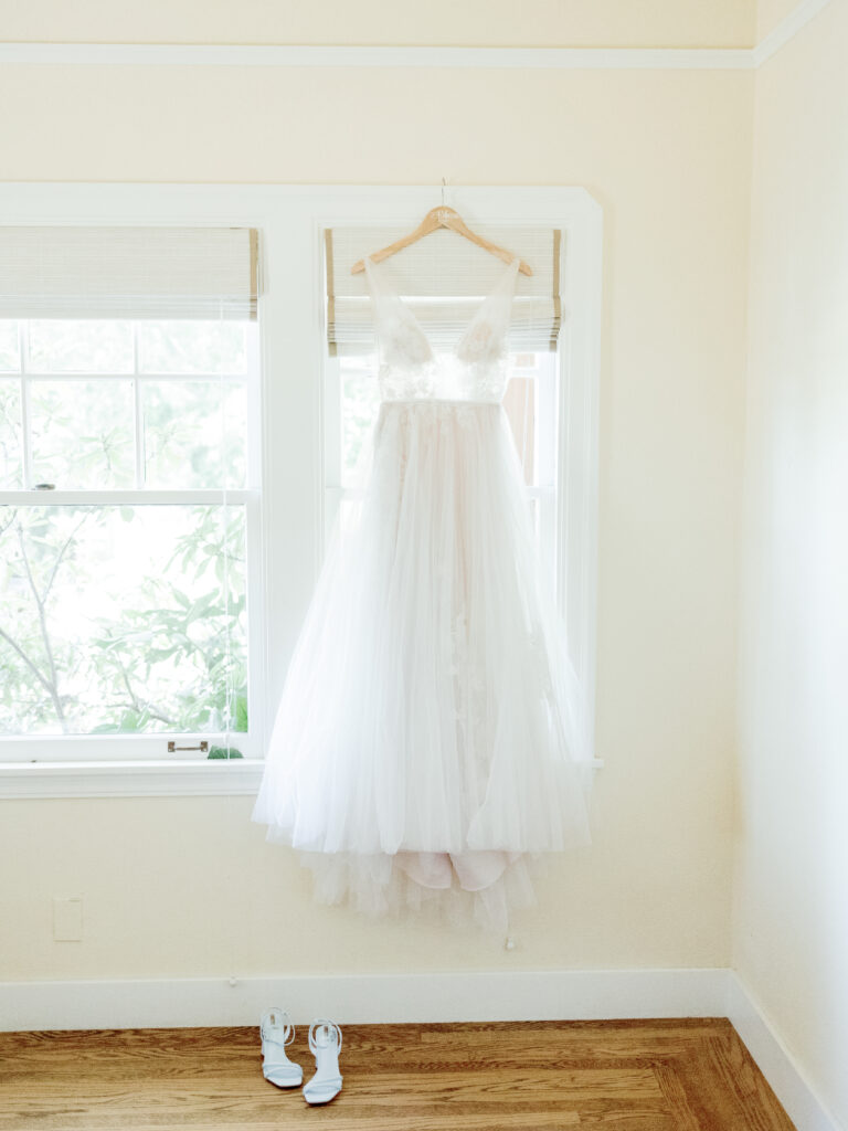 wedding gown hanging in a window.  Tres Posti, Napa Wedding