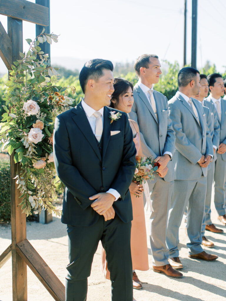 Groom and wedding party looking up the aisle. Tres Posti Napa Valley Wedding