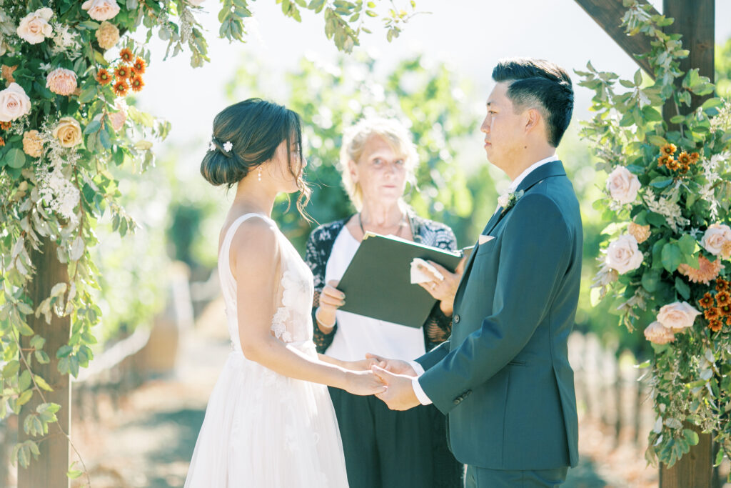 bride and groom exhanging vows. Tres Posti Napa Valley Wedding