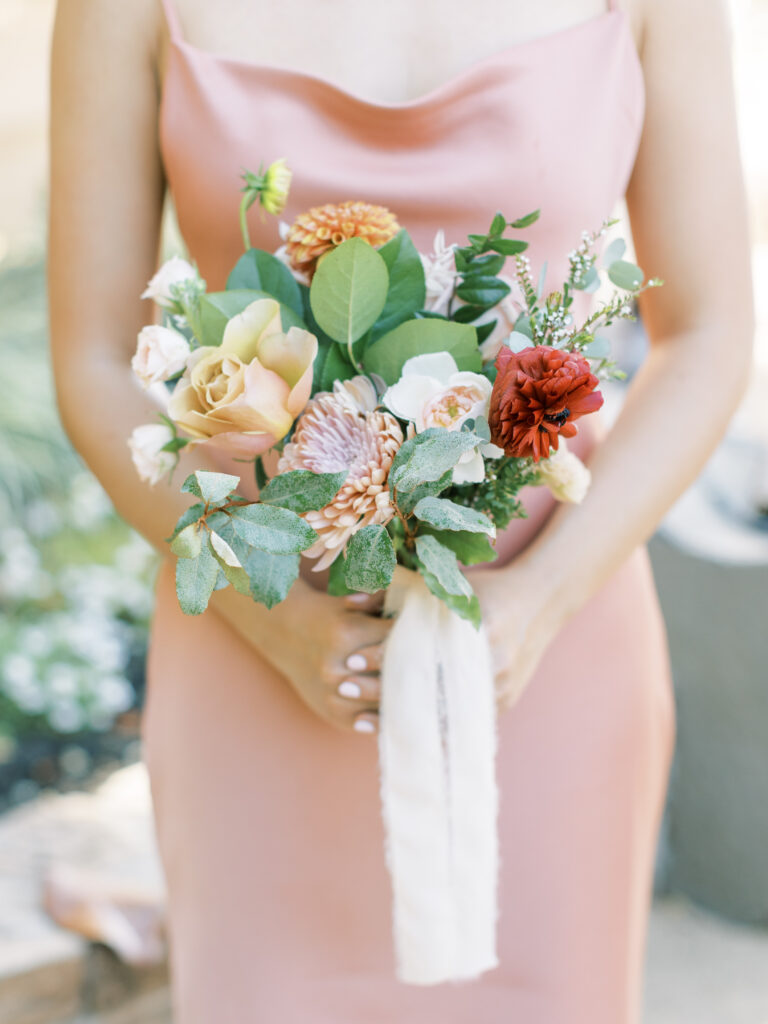 Bridesmaid and her bouqet. Tres Posti Napa Valley Wedding