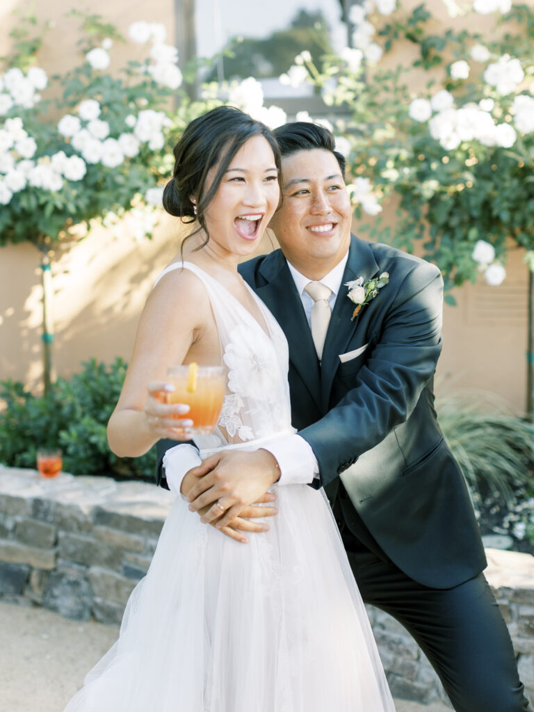 Bride and groom smiling.  bride holding a cocktail Tres Posti Napa Valley Wedding