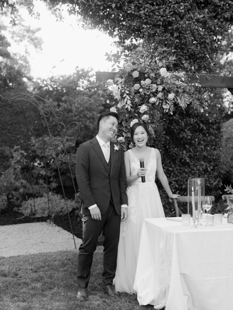 Bride and Groom with microphone. Tres Posti Napa Valley Wedding. Black and white photo
