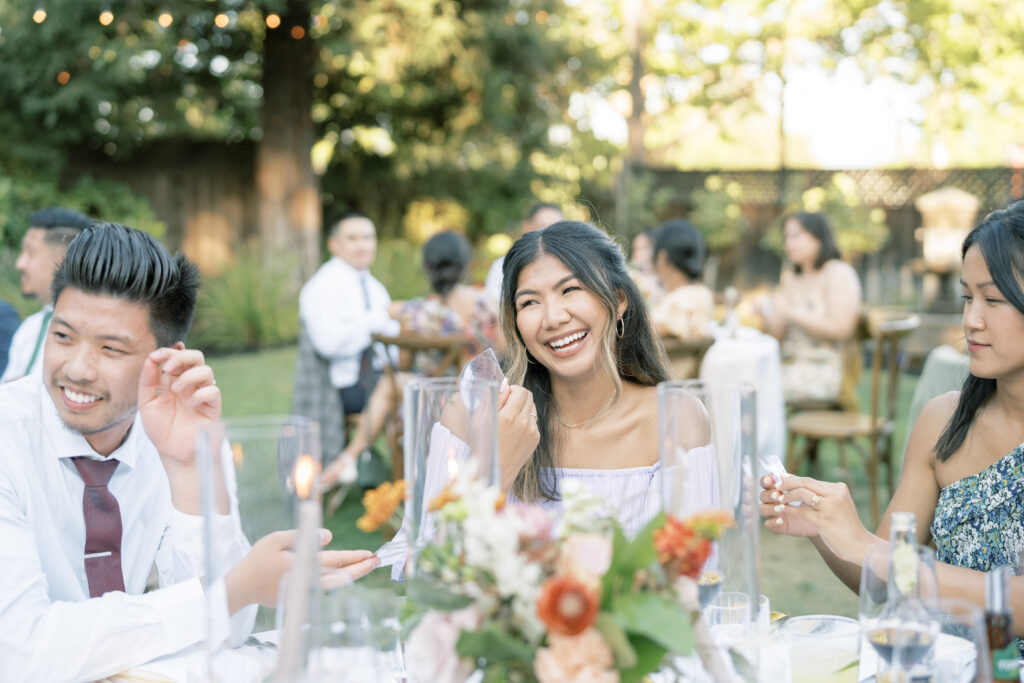 guest smiling and holding a glass. Tres Posti Napa Valley Wedding