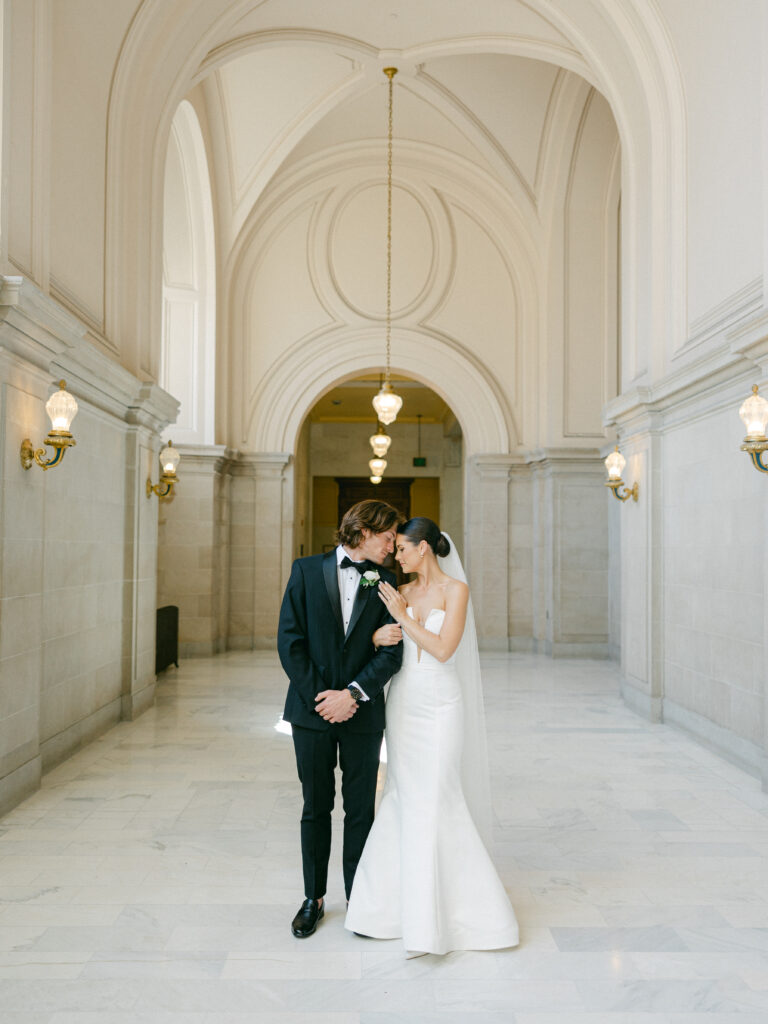 Bride and Groom walking down the hall at San Francisco City Hall