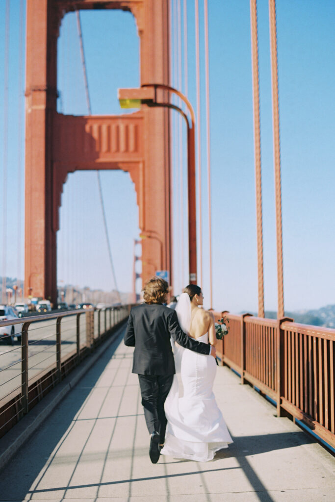 Bride and Groom walking the golden gate bridge