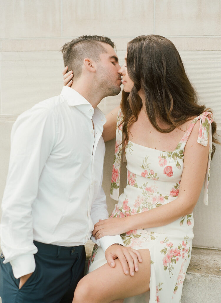 woman kissing man with her hand around the back of his neck