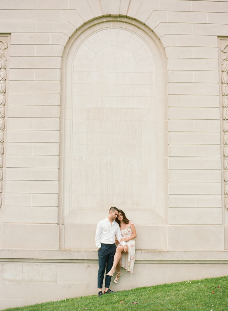 man and woman sitting on a ledge in an archway at the Legion of Honor